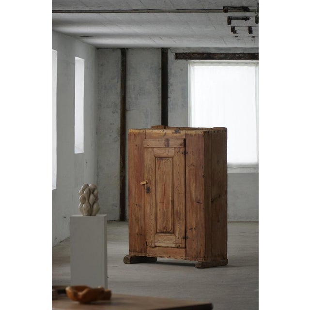 An authentic antique Swedish folk art cabinet crafted in solid pine, dating to the early 18th century. The piece embodies...