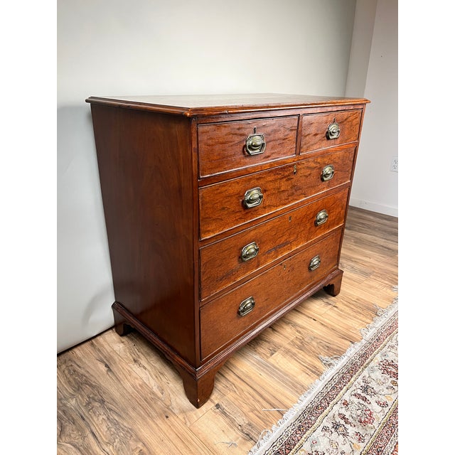 A handsome late Georgian English mahogany chest of drawers dating to the turn of the nineteenth century, this elegant...