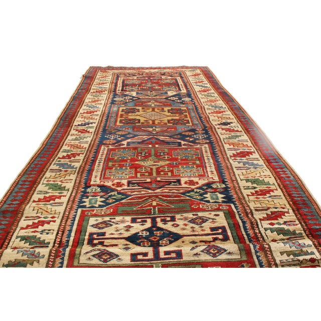 Hand knotted in high-quality wool and originating from Russia in 1880, this antique Kazak runner hosts a unique all over...