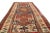 Hand knotted in high-quality wool and originating from Russia in 1880, this antique Kazak runner hosts a unique all over...