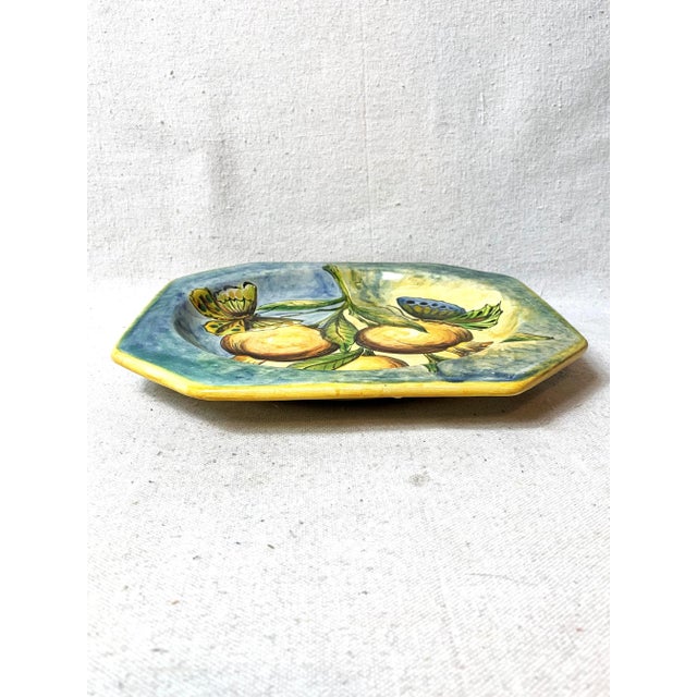 Vintage Santa Rosa Mexican art pottery plate decorated with fruit and butterflies in vivid colors. This is a pre-owned...