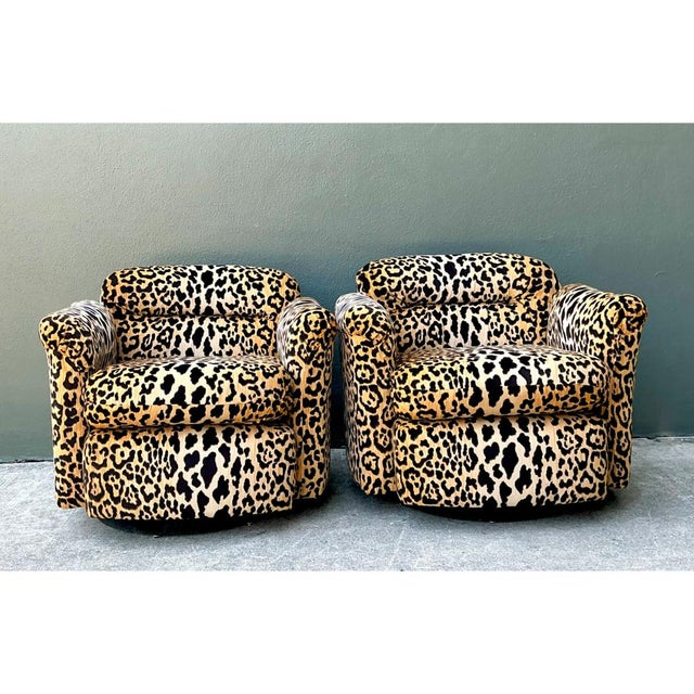 Exuding glamorous mid-century allure, this striking pair of swivel club chairs is upholstered in a rich leopard-patterned...