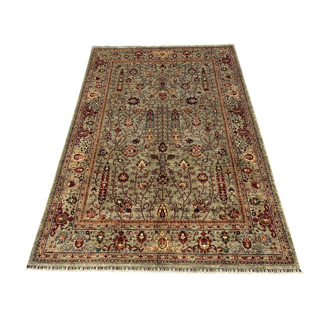 This Sultanabad style area rug has a soft gray field filled with flowering vines, palmettes, and small blossoms. Rust red,...