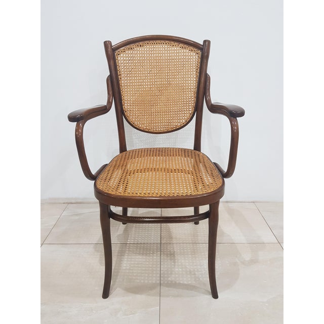 Impressive, signed Thonet studio armchair with bentwood armrests and a raffia backrest and seat, manufactured in Austria...