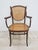 Impressive, signed Thonet studio armchair with bentwood armrests and a raffia backrest and seat, manufactured in Austria...