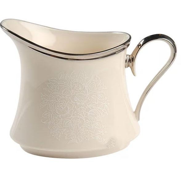 An exquisite vintage three-piece fine porcelain sugar and creamer set manufactured by Lenox in the classic "Moonspun"...