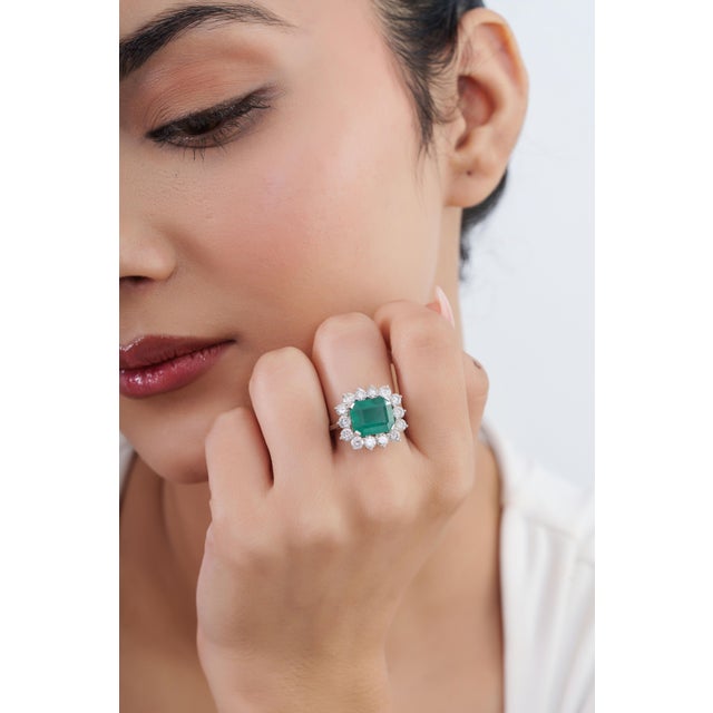 This vintage-style cocktail ring features a 4.1 ct emerald set in 14K white gold. The center stone measures 10.8 × 9.2 mm,...