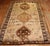 A thick pile tribal Turkish Kars Rug with a large-scale geometric design on a brown field dated 1976.