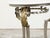 An Italian steel side table from the mid 20th century, with white veined marble top, acanthus leaves and hoofed feet....