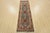 A traditional tribal Heriz runner hand-knotted with an all-wool pile on a cotton foundation. This oriental rug features...