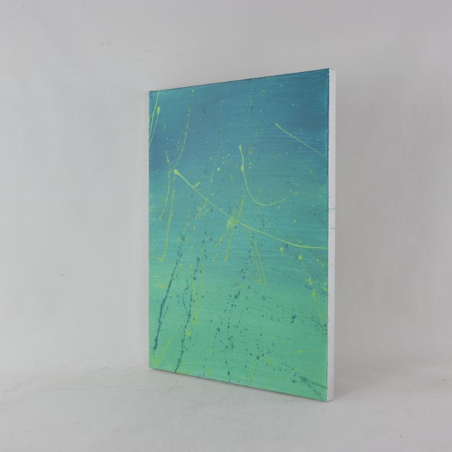 This dynamic modern art piece evokes the rhythmic energy of the ocean through a vibrant, layered composition of teal,...