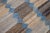 This Deco flatweave wool runner exhibits a captivating blue field with brown and beige accents, creating a contemporary...