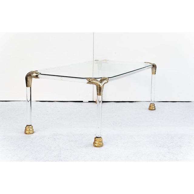 Acrylic glass and brass coffee table, Made in Italy, 1970s. The frame and legs are made of acrylic glass with a glass top....