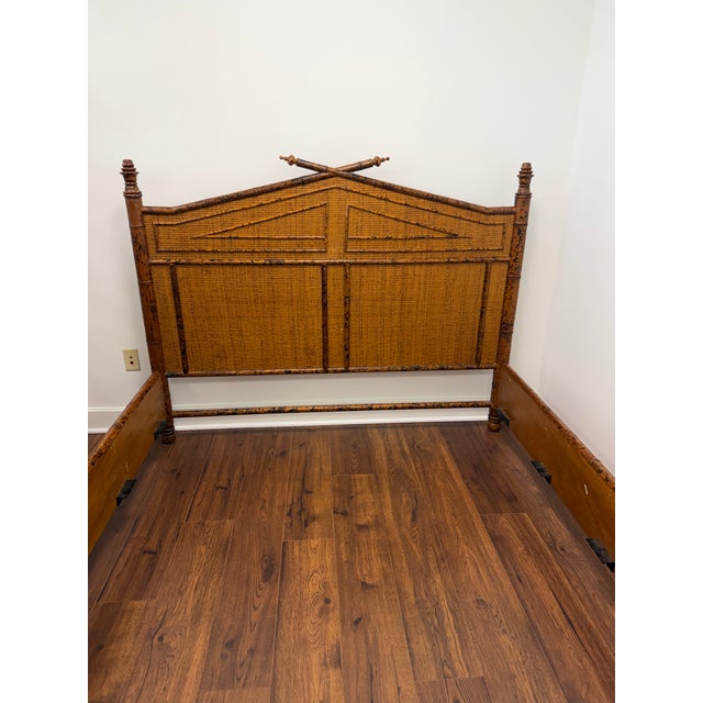 British Colonial Burnt Bamboo Queen Bed in as found vintage condition. Originally retailed by Bloomingdales. A mid-century...