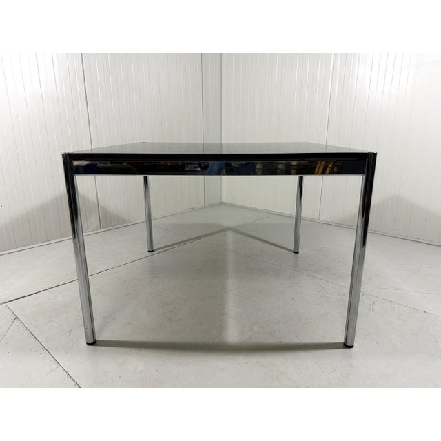Beautiful square dining table by Fritz Haller for USM Haller, Germany. Black ash tabletop, chrome plated frame and legs....