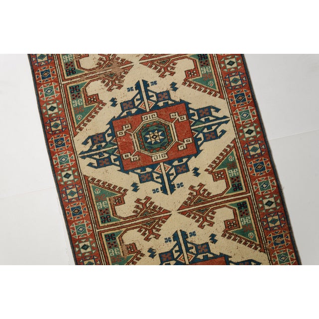 This is a vintage Turkish Oushak rug from the Mid 20th Century. The piece was hand-knotted.