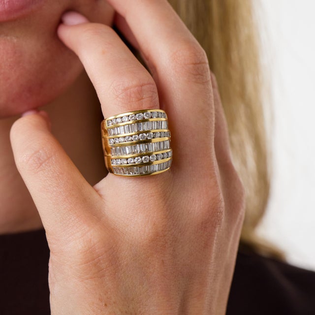 This striking vintage diamond cocktail ring is a glamorous 1980’s design, set with 36 round brilliant cut diamonds...