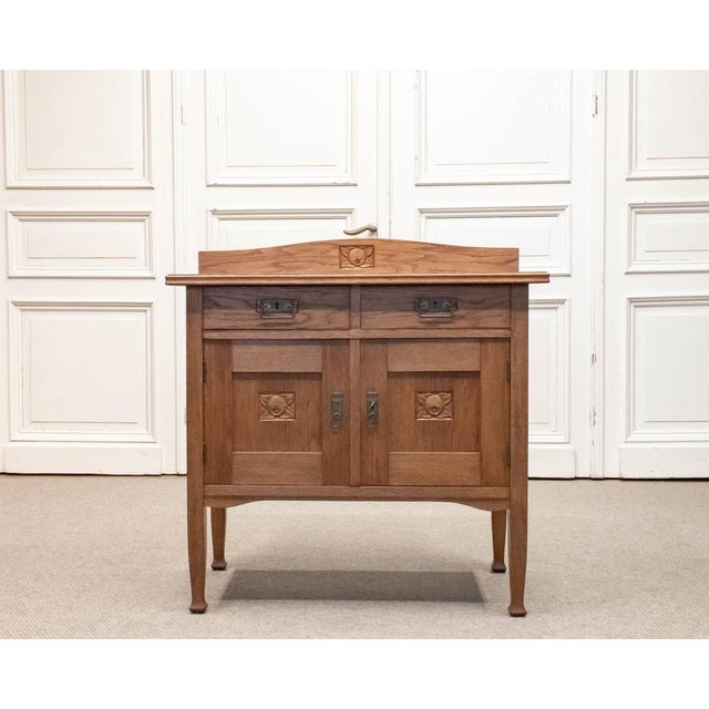 1930s Swedish Jugendstil cabinet crafted from solid oak. The piece features two drawers above a double-door cupboard,...