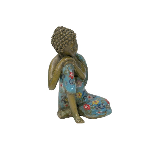 Invite a sense of profound peace and artistic elegance into your space with this exquisite Resting Buddha statuette....