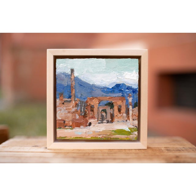 This oil on canvas work depicts the ancient ruins of Pompeii, capturing the remnants of stone structures against a...