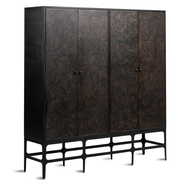 Bold architectural lines meet artisan-inspired character in this four-door iron storage cabinet, featuring richly textured...
