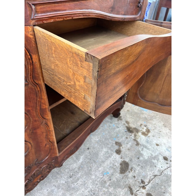 Elegant French 19th-century Louis XV provincial two-door buffet, crafted in solid walnut. Featuring richly carved Rococo-...