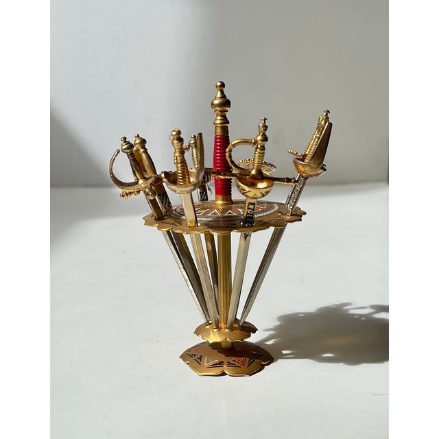 A novel Spanish Souvenir from the 1970s in the shape of this sword skewer set. 8 swords in a matching stand. Made from...