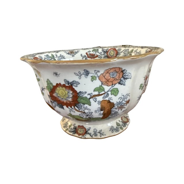 A richly decorated Ashworth Bros. Hanley ironstone jardinière, c.1890, with vibrant chinoiserie florals, perched birds,...