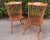 A handsome pair of vintage Windsor-style spindle-back side chairs crafted in warm-toned wood with shaped crest rails,...