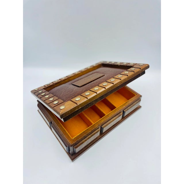 This handsome wood jewelry or treasure box has a touch of a medieval flare to it. This piece is quite versatile and...