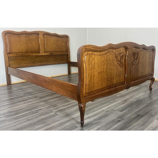 This charming Vintage French Louis double bed is crafted in oak with softly shaped panels and decorative carved detailing...