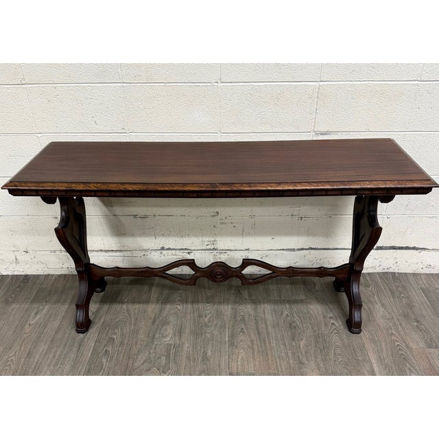 This is a gorgeous vintage Tudor or Spanish Revival style sofa table, console table, or hall table featuring an elegant...