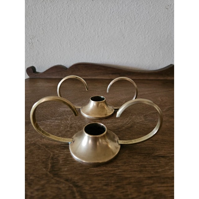 This lovely pair of vintage solid brass candle holders has a unique modern design. There is some minor wear and patina...
