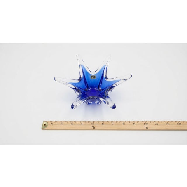 Striking mid-century studio art glass bowl featuring a vibrant cobalt blue center encased and extended by dynamic, free-...