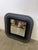 A 1970s-style mirror with a square shape and rounded corners. Made of gray/black lacquered wood. The unique pop-style...