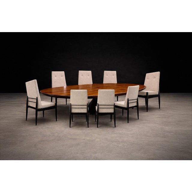 A sculptural and well-proportioned set of eight dining chairs by Cimo, Brazil, circa 1950 — executed in ebonized hardwood...