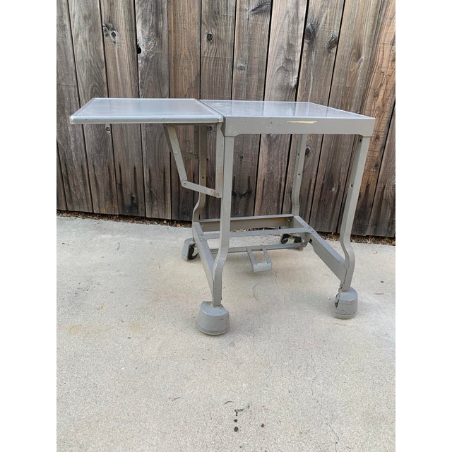 Vintage industrial steel table on wheels. Tiffany drop leaf (from St. Louis). Indestructible. 19” deep - 19”-32”(when...