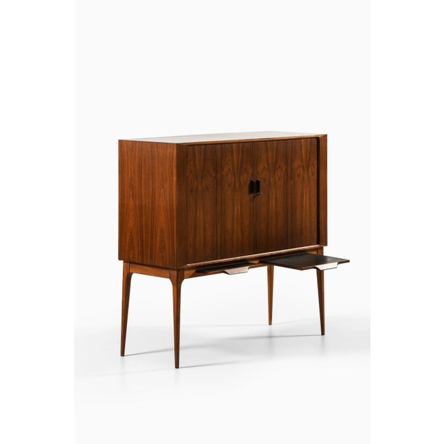 Bar cabinet with tambour doors in rosewood, brass and glass by kurt østervig, 1960's additional information: material:...