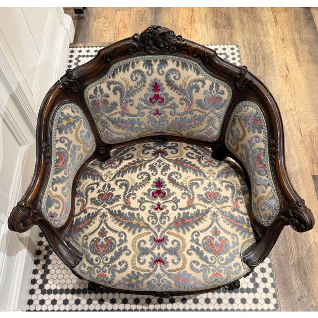 Early 20th Century petite bergère chair with silver-grey needlepoint upholstery, deep red and gold accents and matching...