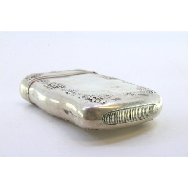 Silver Matchbox with Floral Reliefs and Monogram Card, in Very Good conditions. Designed from 2000 This piece has an...