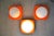 1970s wall or ceiling lights from the Dutch lighting company Herda. The lights are made of orange hard plastic, possibly...