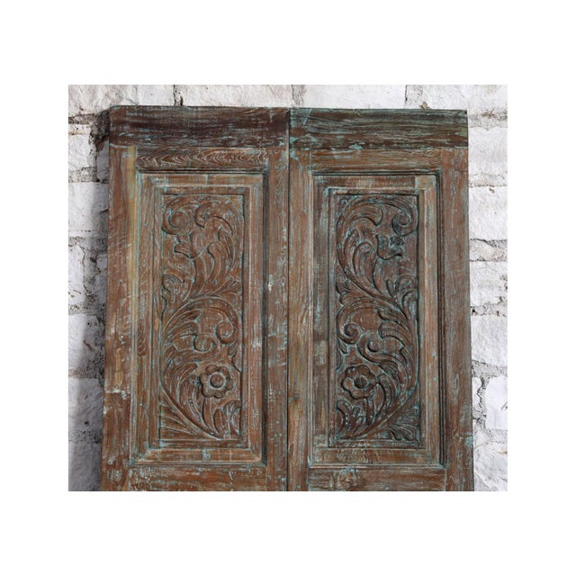 This set of antique carved double doors, featuring an exquisite floral vase motif hand-carved into reclaimed solid wood....