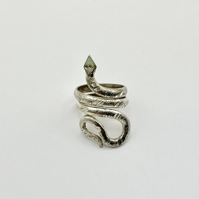 Vintage Home is pleased to offer this vintage Sterling Silver Coiled Snake Ring. It features a Diamond-Head snake that...