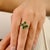 This elegant floral bypass cocktail ring, crafted in 14K yellow gold, highlights four pear-cut natural emeralds totaling...