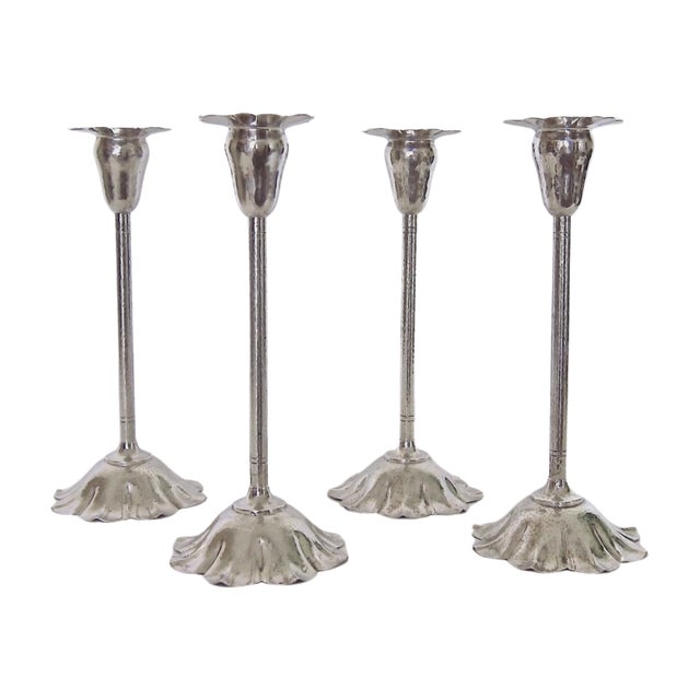 A rare matching set of four antique flori-form candle holders by noted American metalworker, jeweler and designer, Marie...