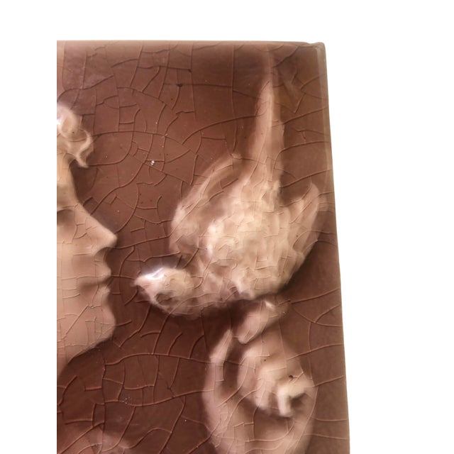 Antique Trent Tile. Child with Bird. Raised Design. 3 dimentional. Embossed. Burgundy Wine Color. Chip on rear top (Does...
