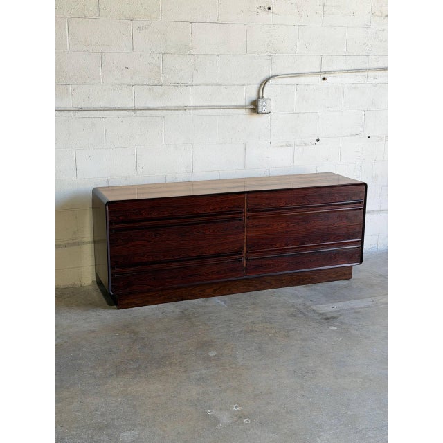 This minimalist credenza profile features soft rounded corner frames and an elegant handleless front configuration. Eight...