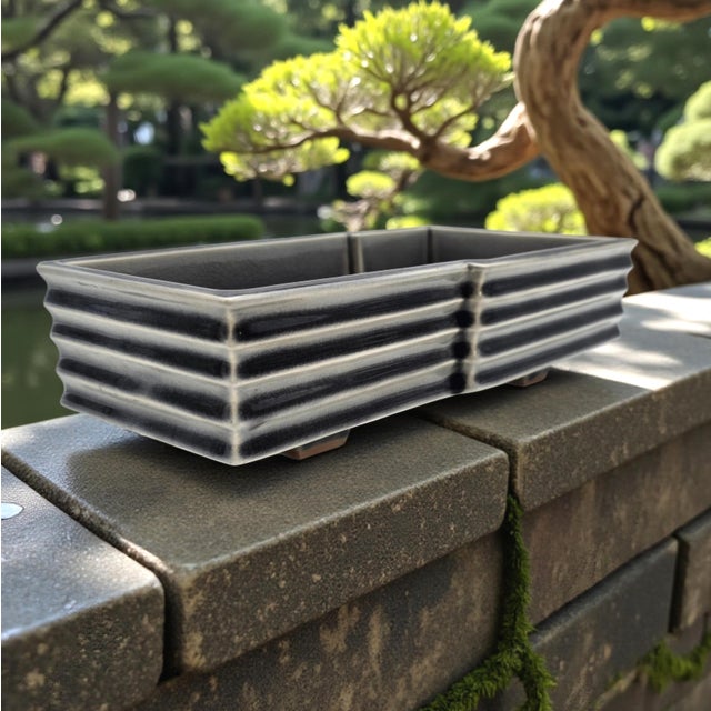 This rectangular ikebana Suiban exemplifies refined late-20th-century Japanese studio stoneware aesthetics. Substantially...