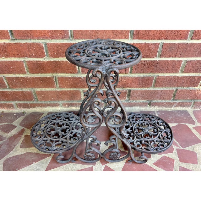 Ornate English Victorian cast iron plant stand has three tiers. Can be used indoors or outdoors and will not be easily...