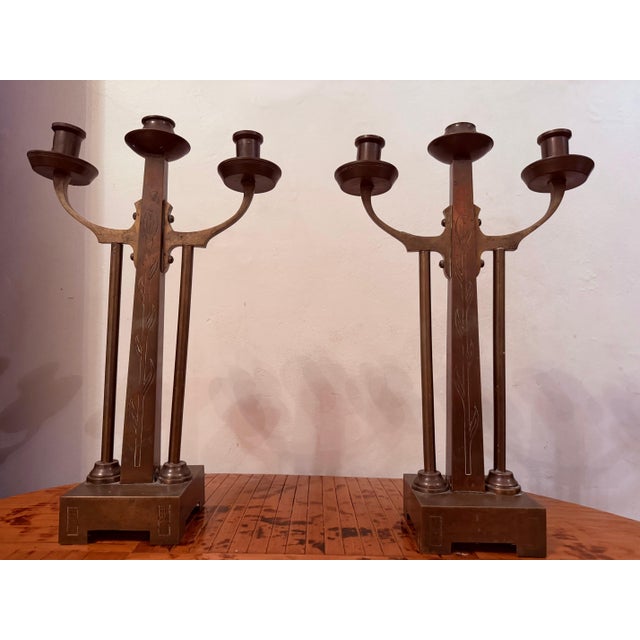 A wonderful original pair of 1915 Dutch Amsterdam School aged brass 3 arm candleholders with decorative elements. Original...